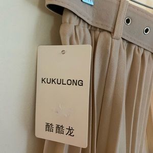 Size small light peach (nude) pleated midi skirt with belt.